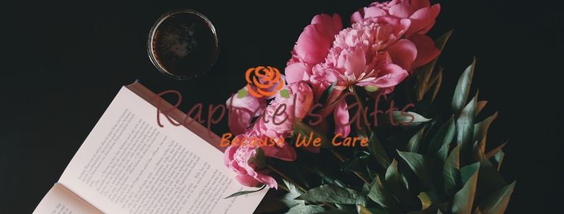 An open book and a bunch of pink flowers lying beside it and Raphael's Gift logo in the middle