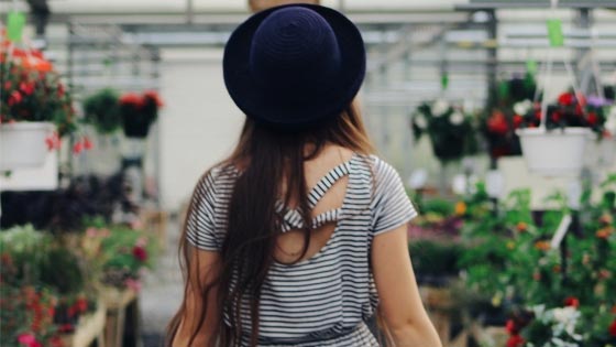 Back view of a girl inside a flower shop