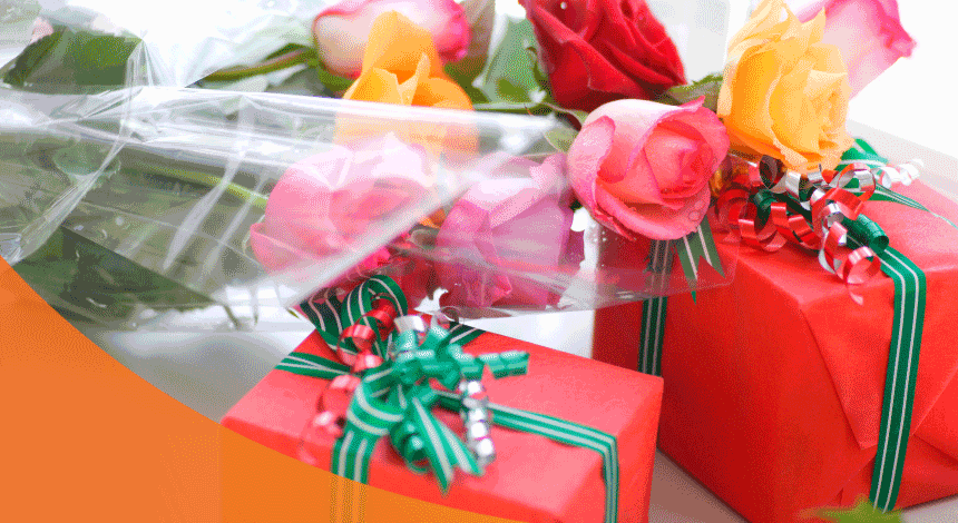 Bunch of colorful flowers and two holiday gifts